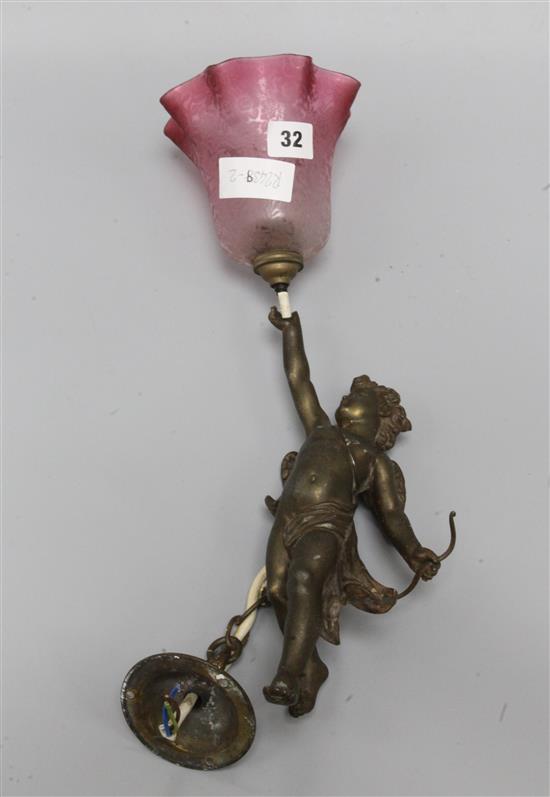 A cherub hanging lamp with cranberry shade